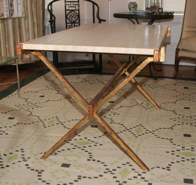 An Antiqued Gilt Iron "X"  Base and Travertine Topped Table