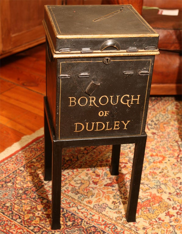 This is an original voting ballot box. It is inscribed from the Borough of Dudley and has handles on two sides and a slot on top, to place your ballot. This ballot box is sitting on a metal stand(new ). This would be a sterling small side table,