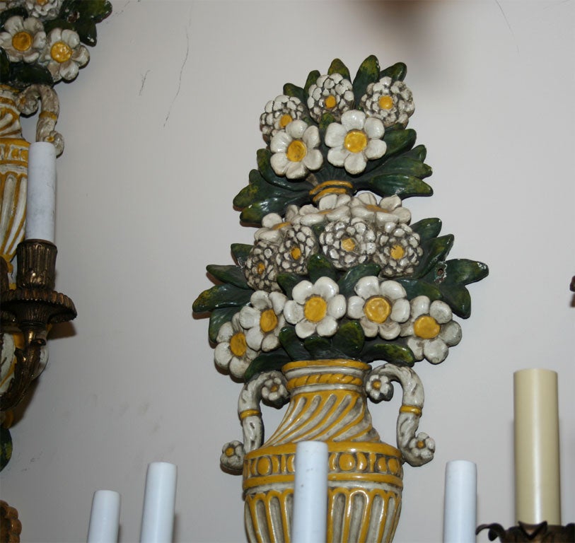 A set of four Renaissance style wall sconces with enameled copper polychrome bouquets issuing from urns and having detailed bronze candle arms and bobeches. By American maker Caldwell. CIrca 1910. 29