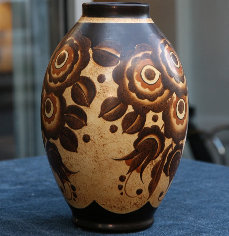 Hand painted ceramic vase with<br />
stylized floral designs in shades<br />
of creme, tans, and browns. Signed.