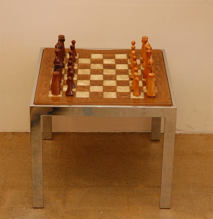 This one-of-a-kind side table has a modern chrome base and chess board top in rich earth tones.  Complete with wooden chess set by Herman Ohme circa 1950’s.
