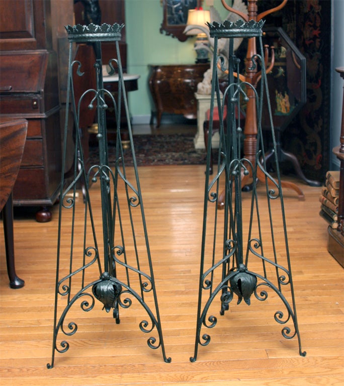 Pair of fanciful Art Nouveau wrought iron plant stands with the original makers<br />
label 