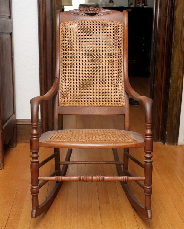 This cane walnut rocking chair is a beautiful piece.  It rocks well and the wood is beautiful.  The caning is totally hand restored.  The seat is generous enough for DAD!