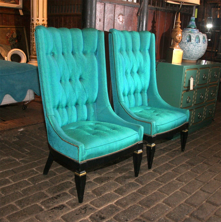 Pair of tufted high back chairs with black painted stylized Louis XVI legs.