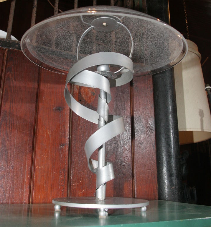 Moderne silver painted desk lamp with glass shade.