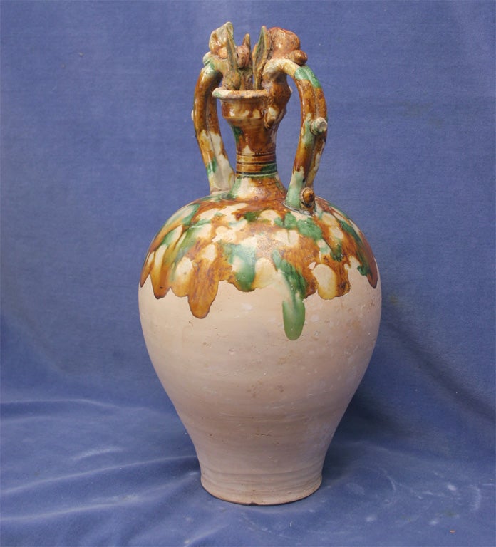 Buddhist Water Botle Complemented by Greco-Persian Amphora Style Handles Modified to Show Chinese Dragons Biting the Rim.<br />
Decorated with Cream, Green and Chestnut Wax Resist Glaze.