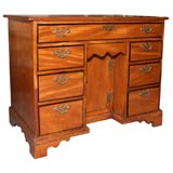 Antique English teakwood kneehole desk.