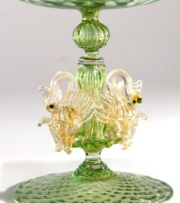 Hand blown Venetian figural compotes with gold leaf inclusions. Complex stems with three applied clear swan figures with gold. Color in photo is  darker than in person.