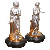 A Pair of Tiffany Stamped Silvered and Dore Bronze Scultpures