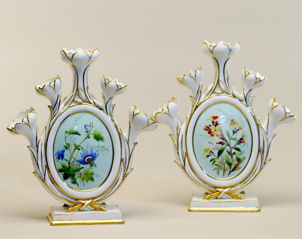 Rare pair of Royal Derby porcelain tulipieres.  Hand painted on both front and reverse medallions with botanical specimens. Perfect mantle pieces with or without flowers.