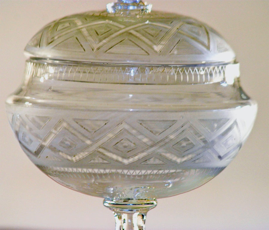 An unusual and elegant hand blown and wheel cut and frosted crystal 
sweetmeat dish with matching underplate decorated in a geometric pattern. The lid is notched for a ladle, making it perfect for preserved fruit or cranberry sauce or your favorite