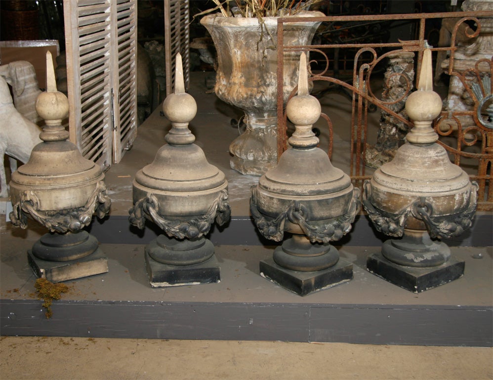 Set of four English stoneware finals, with boldly swaged garlands, signed Stiff & Sons. The Stiff pottery was founded by James Stiff in Lambeth, South London around 1842, became Stiff & Sons in 1862, and ceased production in 1913.