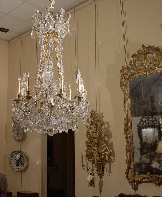 A fine gilt-Bronze and cut-Crystal Chandelier, with eight(8) lights and dozens of both cut and pressed-Crystal pendants. The gilt-Bronze frame with unusual rectangular chain-links and geometric design, illustrated wonderfully by Image #10. The arms