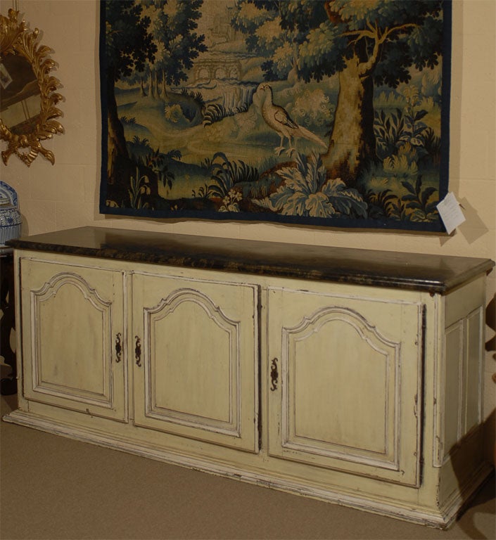 A Louis XV design Enfilade, with painted finish in a cream color, capped by a striated marble top in conforming shape. Dating from the mid-1800s, and provencial French in origin.<br />
<br />
The marble top with moulded edge and rectangular form,
