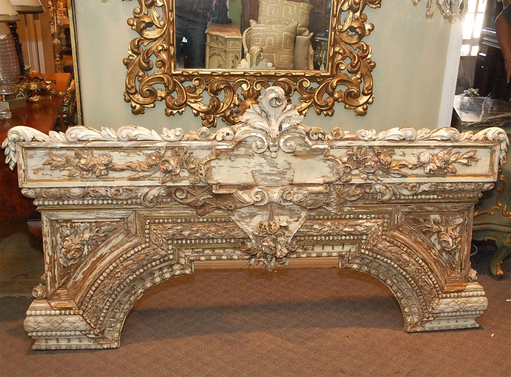 The graceful arch of this early 19th C. painted and hand carved architectual piece is covered with roses and floral vinettes with beading, swags, and fine moldings.  This piece is all hand carved with remnants of gesso and paint remaining on the