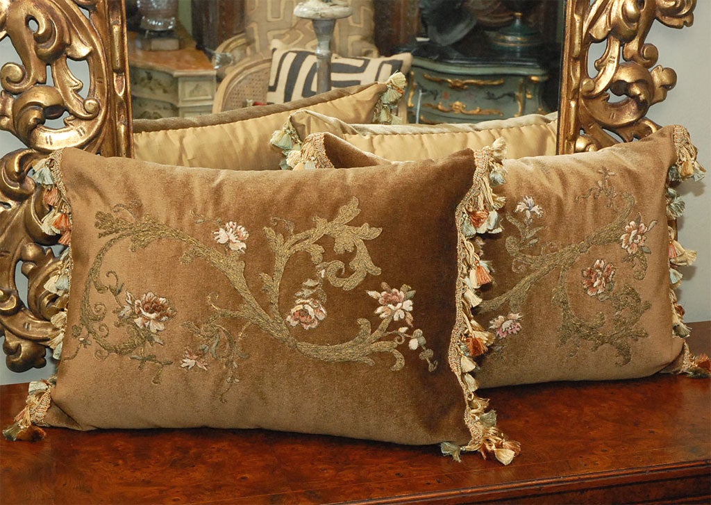 A graceful swirl of metallic golden threads stretched across a bed of honey colored velvet spreads across the soft surface into a beautiful natural design.  Springing from this abundance of golden threads are soft muted tudor roses which make a
