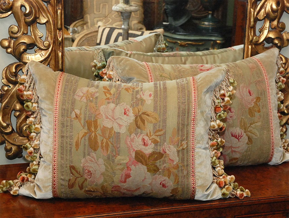 Cascades of cabbage roses spread the beauty over the surfaces of these wonderful tapestry fragments.  Unique and rare metallic stripes run down the background of these remnants.  Soft rose, pink, yellows, browns, and greens add to the ambiance of