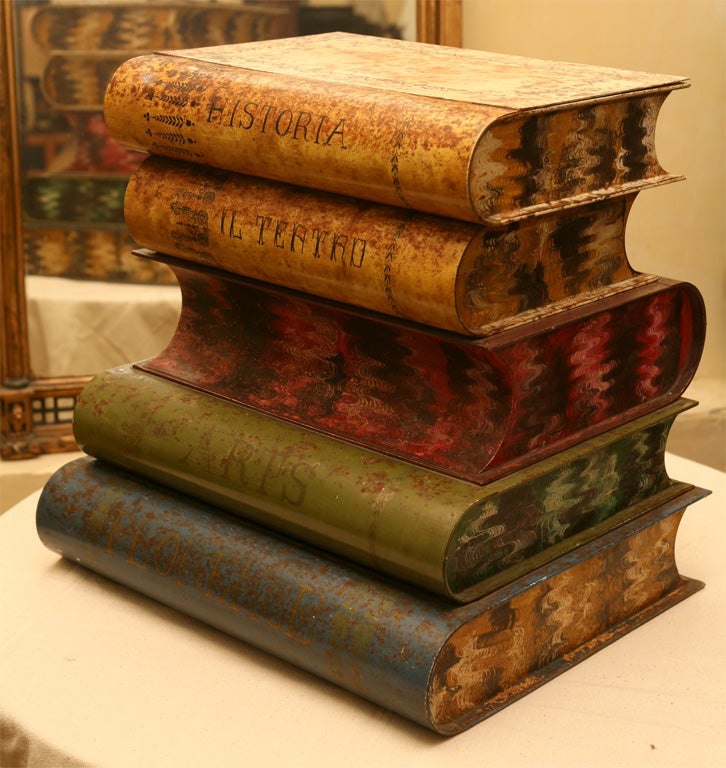 A very decorative low smoking table in the shape of a stack of books. The edges are marbleized in different colors for each book as is the spines of the books. The table opens up for storage.