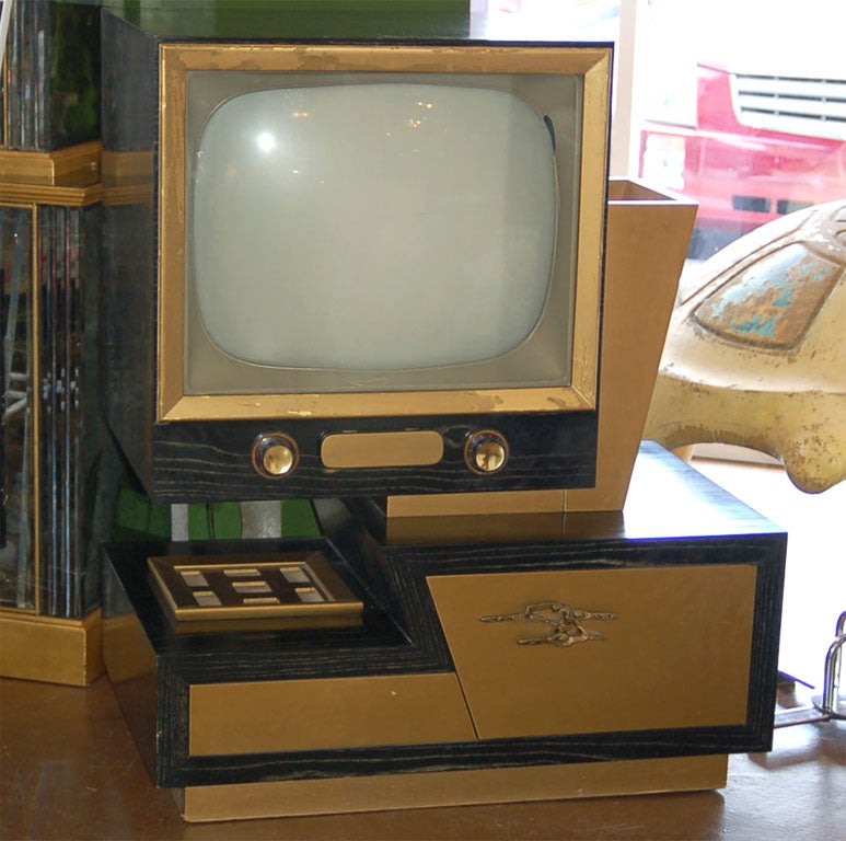 Futuristic 1950's television cabinet in the style of James Mont. Would make a great cabinet for an aquarium or flat screen.