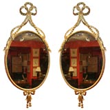 Pair Of 19th Century Oval Gilt Ribbon Mirrors.