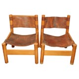 Pair of low oak and leather chairs in the style of Pierre Chapo