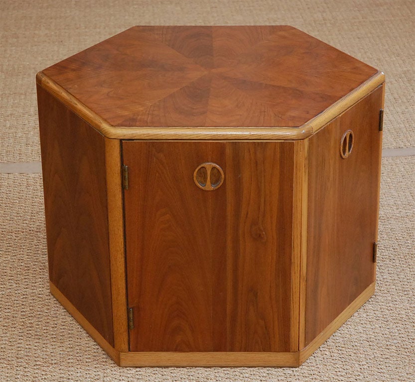 Six sided table with plenty of storage space.  Two of the sides are doors.  Contrasting woods.