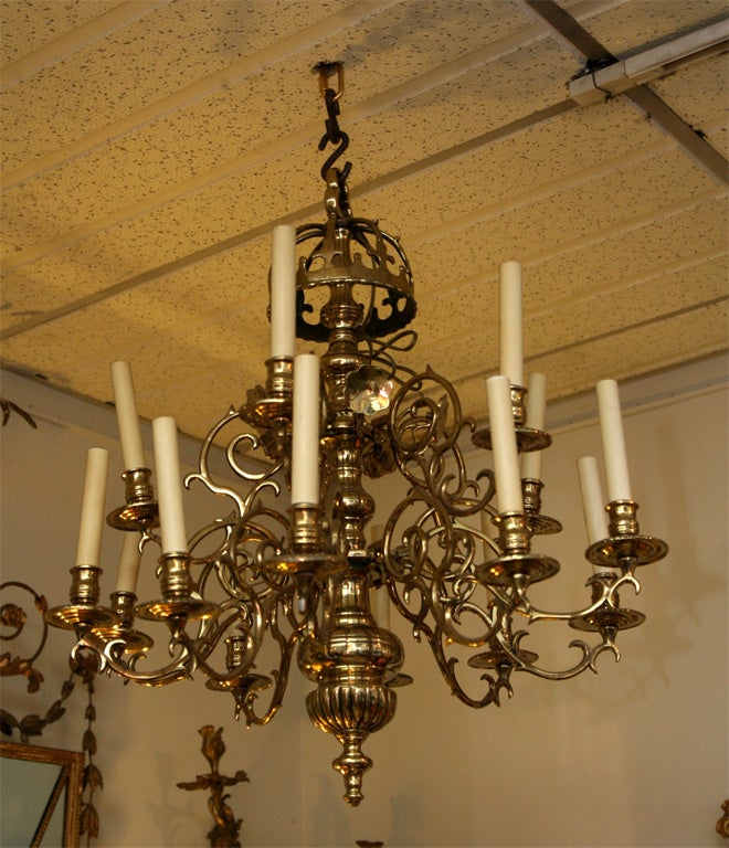 Early brass fifteen-arm two-tier chandelier with crown and reflectors.