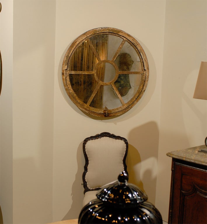 Painted wrought iron window frame with antiqued mirror.