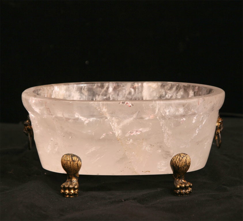 Roman style rock crystal miniature tub with  bronze lion paw feet and lion mask handles.