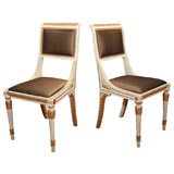 A Pair of Empire Cream Painted and Parcel Gilt Gondola Chairs