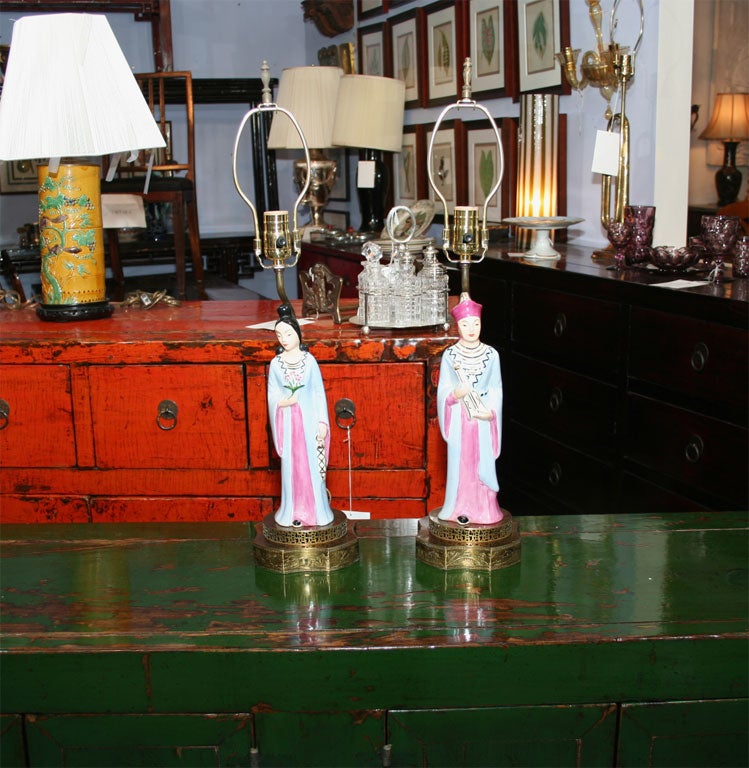 Great lamps that are filled with humor lovely colors and superb execution.   Brass Base.  Man and a woman.  Newly rewired.