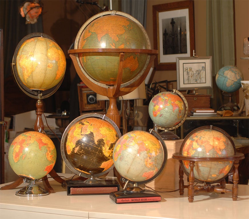 A Collection of Seven Illuminated Globes, by various American makers; Cram's, Rand McNally, and Replogle.  <br />
The glass globes with paper maps applied on various wood and metal stands.  Two of the Replogle Globes have Atlases in the Stands. 
