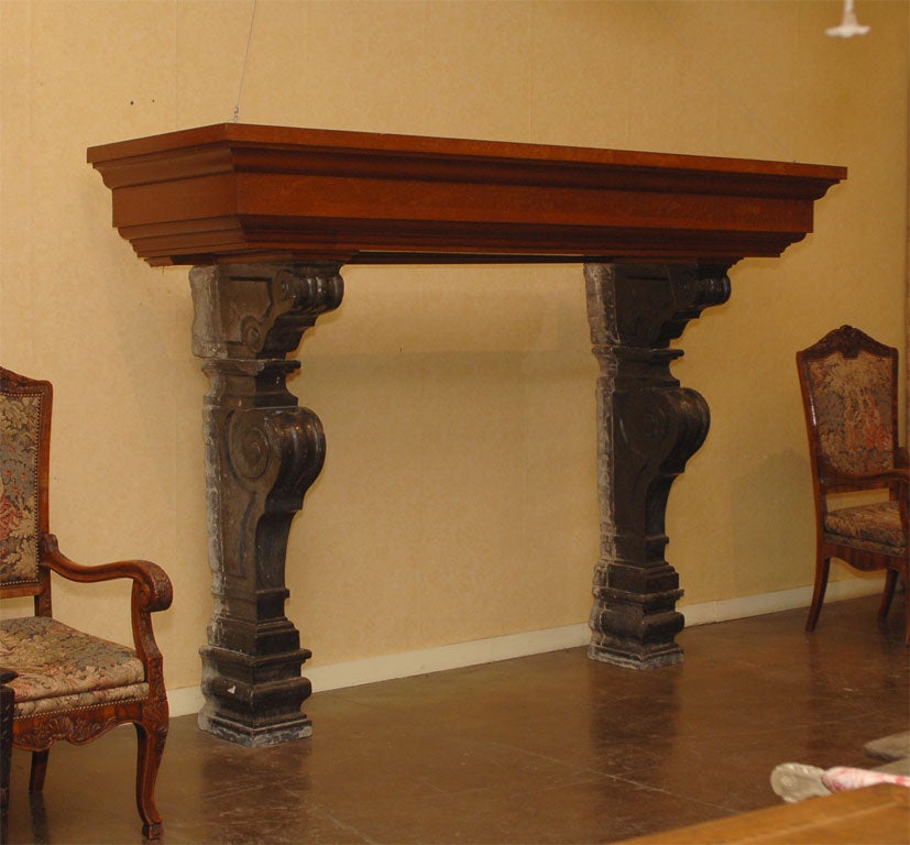 A grand scale hand carved marble and oak fire surround. the volute supports of marble is circa 1750, the oak mantle is later, from the 19th century.