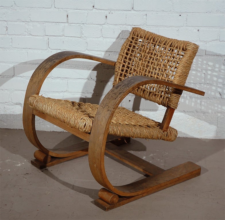 This Unique Lounge chair is Attributed to the French Duo Audox-Minet.  Fantastic Classic Modern Design Cantelievered Frame on Wood Runner Legs with a newly strung Seat & Back.