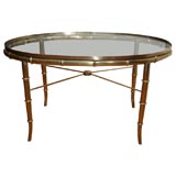 Oval glass top brass faux bamboo cocktail table