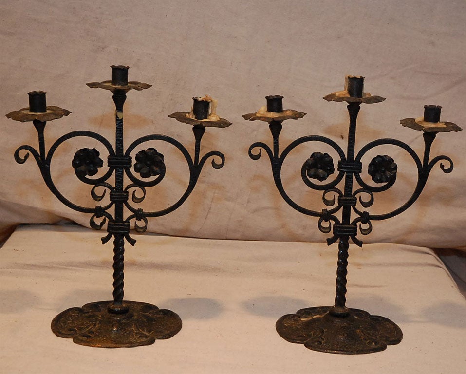 These Gothic inspired hand wrought candleholders have all the twists and hammer marks an expert expects to see in quality iron work.  These were made in the 19th Century for the Gothic Revival Period.  Picture these candelabras on a fireplace