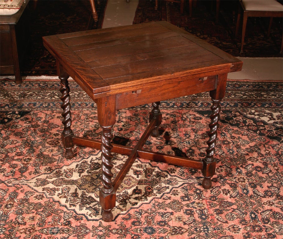 Square oak pub table with barley twist legs. Two 9-inch leaves open this oak pub table.