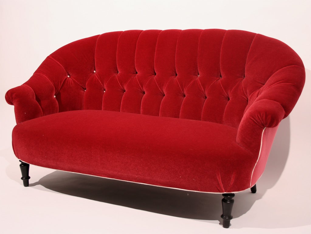 A Napoleon III Red Mohair Velvet Loveseat with Shaped Back and Featuring White Piping and Buttons on Ebonized Turned Legs