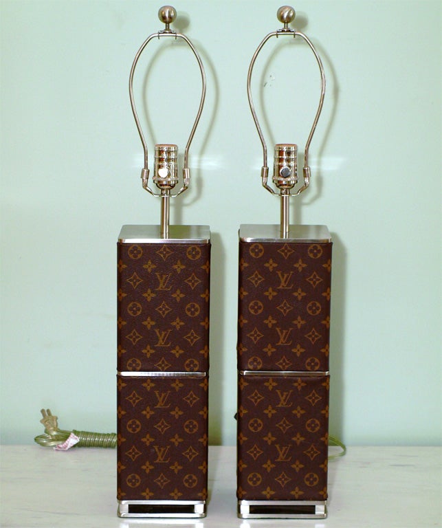 Elegant table lamps with classic LV monogram on leather; square form with stainless steel details at top, bottom and center; sockets with incorporated dimmer switches; measurement to top of finial