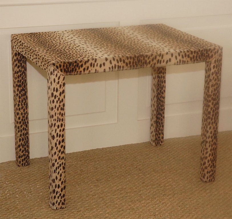 Rectangle game table upholstered in faux leopard fabric. Felted surface provides a non slip surface for decks of cards and other table top games.