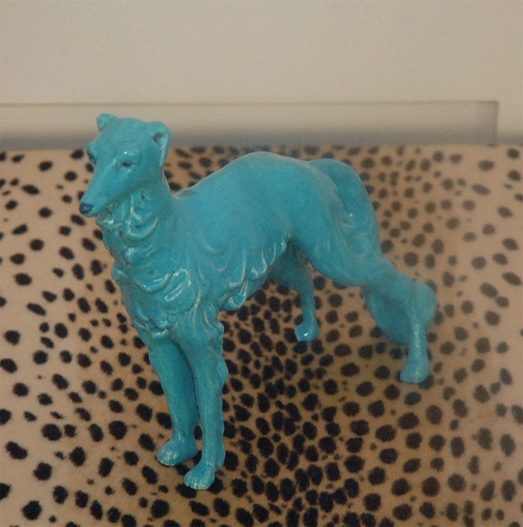 Elegant Saluki dog statuette in glazed turquoise ceramic. Intense care has been taken to render the shape and volume of coat and tail in high relief. Details such as the eyes and snout have been handpainted in a dark navy blue and black.