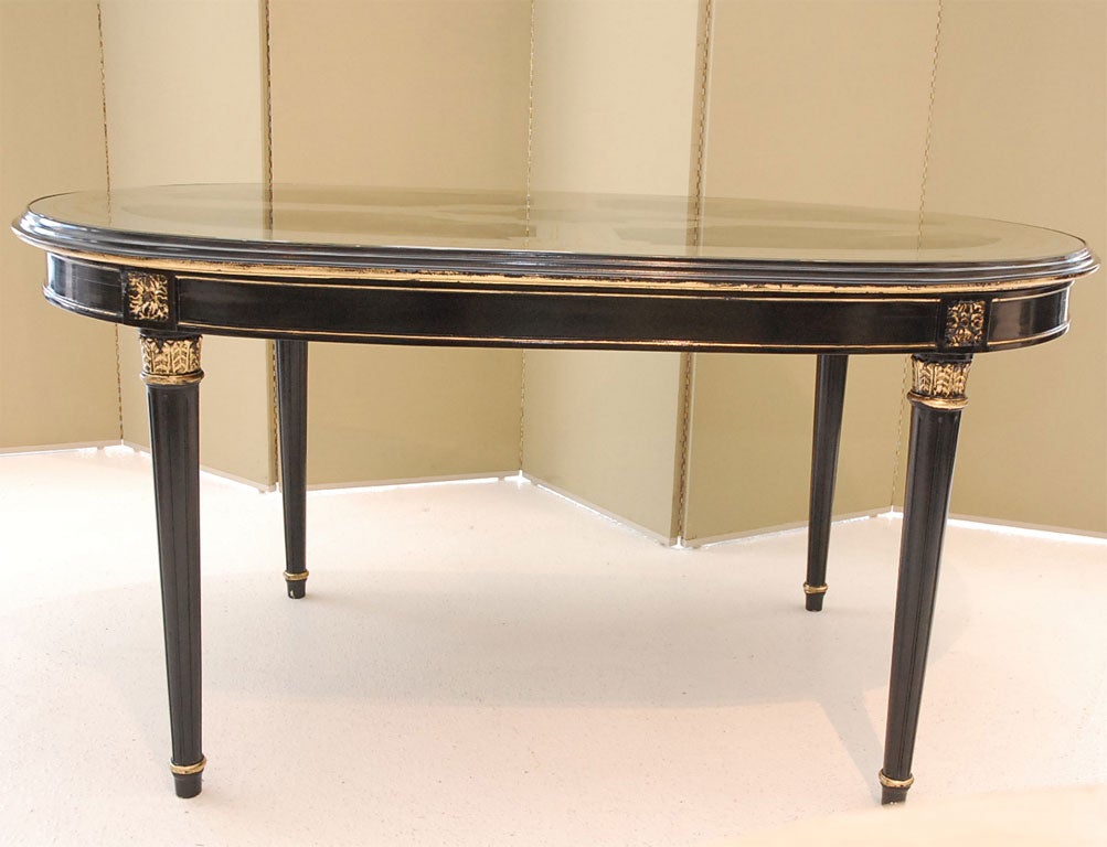 French An Ebonized, Gilt, and Eglomise Oval Dining Table signed Jansen