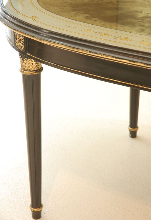 An Ebonized, Gilt, and Eglomise Oval Dining Table signed Jansen In Good Condition In Palm Desert, CA