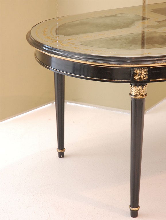 An Ebonized, Gilt, and Eglomise Oval Dining Table signed Jansen 4