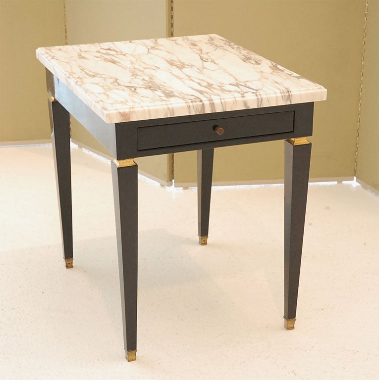 Lovely black lacquer single drawer side table with gilt detail and marble top, signed Jansen.