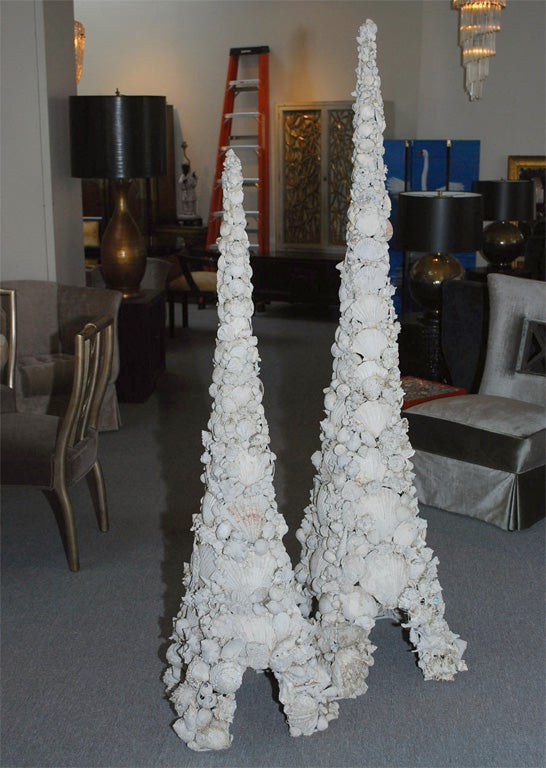Grand pair of shell towers in the style of Tony Duquette. The wire bases have been encrusted with hundreds of varying shells that make up these spectacular and monumental pieces.