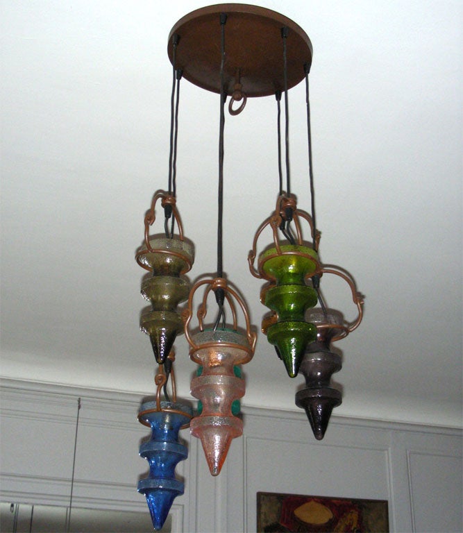 1970s chandelier with seven hanging elements in moulded and colored glass, with adjustable cables. Another is available, price quoted is for one.