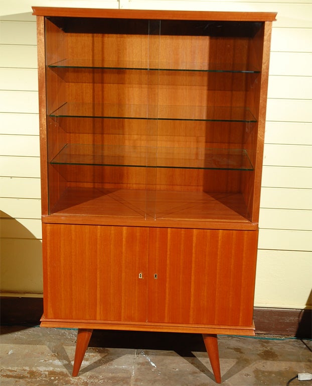 Pristine and functional display case. Sliding glass doors open to three glass shelves.  Doors on the bottom open to 1 wooden  shelf(missing on the picture).  Delicate edges and outward pointed legs.<br />
The matching dining table and sideboard are