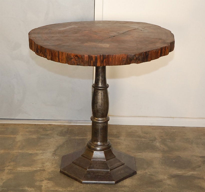 Dare we say this is an unusual table. The cross section of an oak (?) tree has been fixed to an iron pedestal. The edges of the cross section are irregular along with the overall diameter of the top.