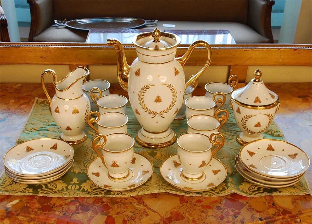 A lovely Vieux Paris porcelain coffee service with gilded Napoleonic emblems, including bees, stars and laurel wreaths.  The set includes a coffee urn with cover, creamer, sugar with cover, and ten cups and saucers -- 25 pieces in total.  Each piece